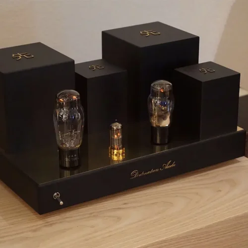 Three Vista 3-Way Horn Speakers of varying sizes displayed on a black staircase-like stand with the logo "Destination Audio" inscribed, set against a wooden surface.