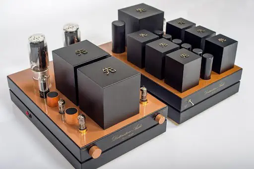 GM70 Integrated Amplifier with copper base, large black transformers, and visible vacuum tubes on a white background, designed for audiophiles. GM70 Integrated Amplifier with copper base, large black transformers, and visible vacuum tubes on a white background, designed for audiophiles.