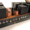 Audio mixing console with multiple input jacks and a series of black and copper controls on a Destination Audio desk, featuring The Phono Stage. Audio mixing console with multiple input jacks and a series of black and copper controls on a Destination Audio desk, featuring The Phono Stage.