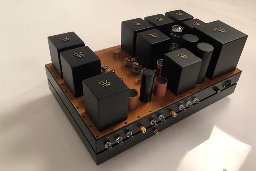 A Phono Stage amplifier on a base, featuring multiple black electronic components. A Phono Stage amplifier on a base, featuring multiple black electronic components.