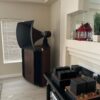 Vista 3-Way Horn Speakers sit by the fireplace, flanked by two red lanterns on the mantle, while audio equipment rests on a black table in front. Vista 3-Way Horn Speakers sit by the fireplace, flanked by two red lanterns on the mantle, while audio equipment rests on a black table in front.
