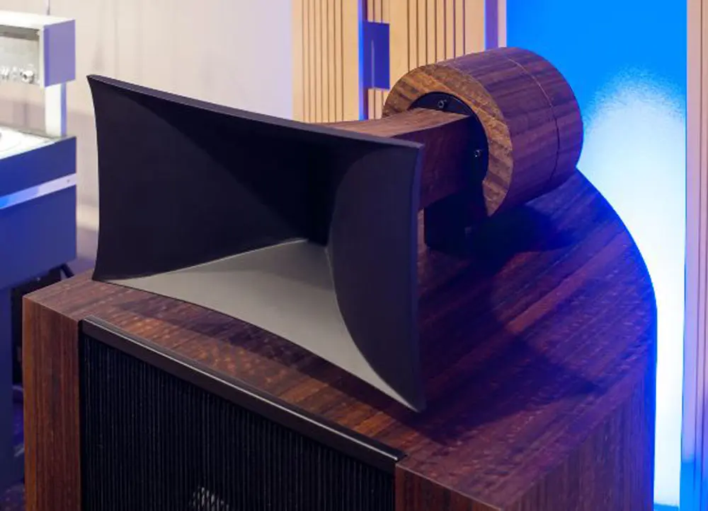 A row of vintage audio equipment including a mixer with multiple knobs and switches, and The Phono Stage, set on a wooden tabletop.
