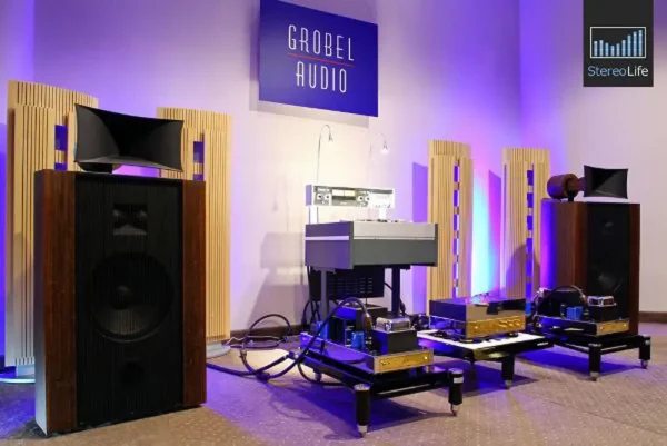High-end audio equipment from Destination Audio displayed in a room with purple lighting, including Vista 3-Way Horn Speakers and various amplifiers. High-end audio equipment from Destination Audio displayed in a room with purple lighting, including Vista 3-Way Horn Speakers and various amplifiers.