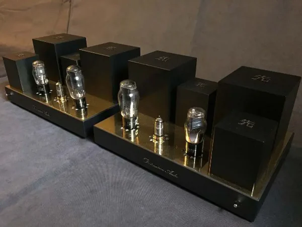 A Vista 3-Way Horn Speakers preamplifier with visible vacuum tubes and sleek black casing, displayed on a gray fabric surface. A Vista 3-Way Horn Speakers preamplifier with visible vacuum tubes and sleek black casing, displayed on a gray fabric surface.