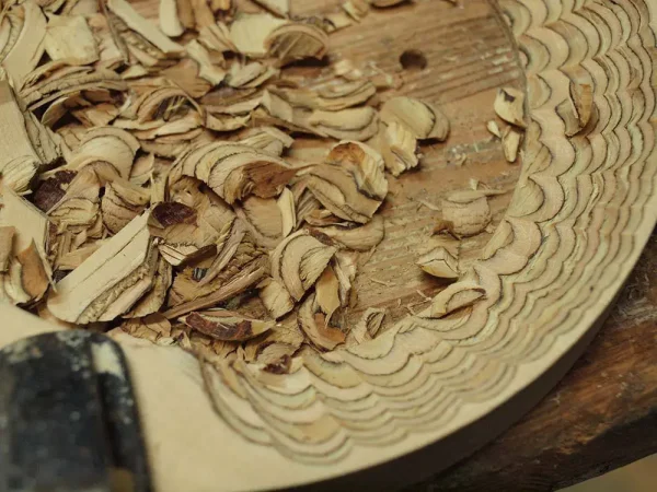 Wood shavings on a carved wooden surface with a carving tool and Vista 3-Way Horn Speakers visible in the foreground. Wood shavings on a carved wooden surface with a carving tool and Vista 3-Way Horn Speakers visible in the foreground.