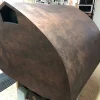 A large, geometric wooden Vista 3-Way Horn Speakers with a dark, swirling grain pattern and a pentagonal opening, displayed indoors. A large, geometric wooden Vista 3-Way Horn Speakers with a dark, swirling grain pattern and a pentagonal opening, displayed indoors.