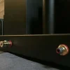 Close-up of a black Vista 3-Way Horn Speakers with vacuum tubes and colored audio input jacks. Close-up of a black Vista 3-Way Horn Speakers with vacuum tubes and colored audio input jacks.