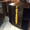 A hexagonal wooden cabinet with an intricate resin inlay on its side, designed to house a Vista 3-Way Horn Speakers, situated in a workshop. A hexagonal wooden cabinet with an intricate resin inlay on its side, designed to house a Vista 3-Way Horn Speakers, situated in a workshop.